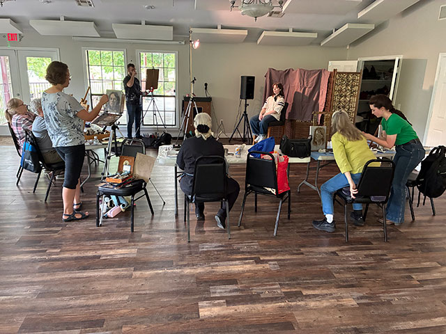 Photo of the participants set up and working around the model.